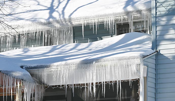 residential home heavy snow and ice damming roof