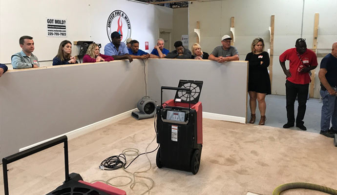 Professional worker are gathering around the flood restoration equipment