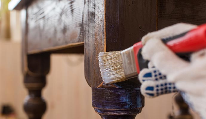 Furniture restoration by worker